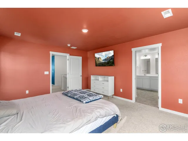 a bedroom with a bed and a potted plant