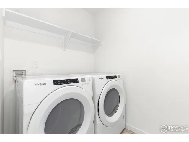 a view of washer and dryer with kitchen in the background