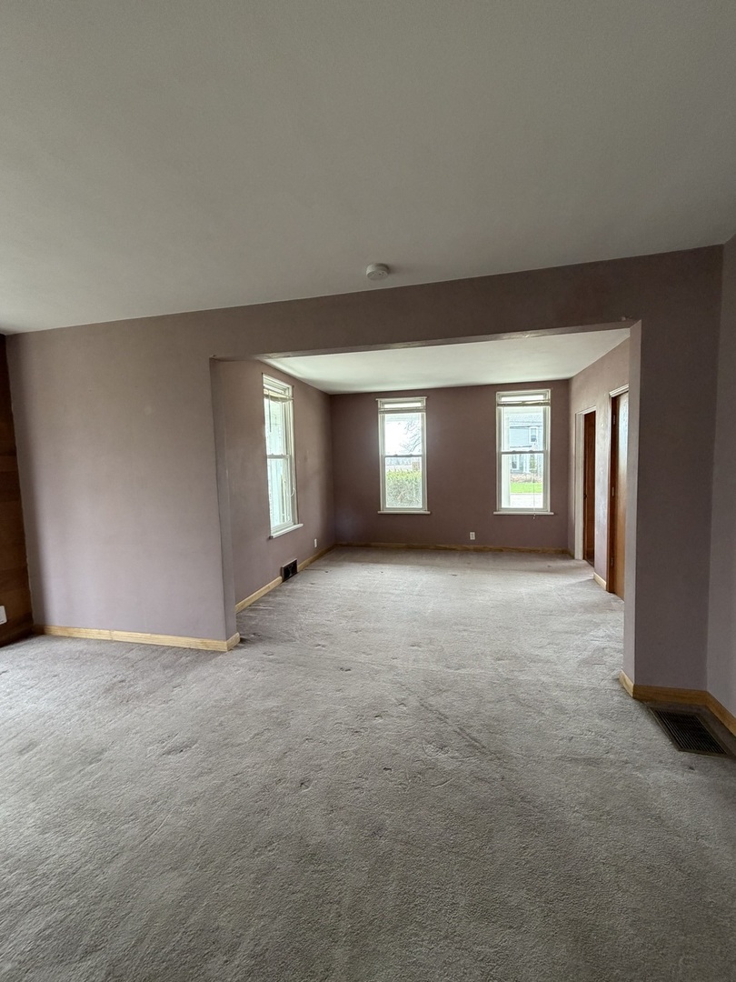 616 East Main Street Amboy, IL 61310 - Photo 13 of 24 a view of empty room with window