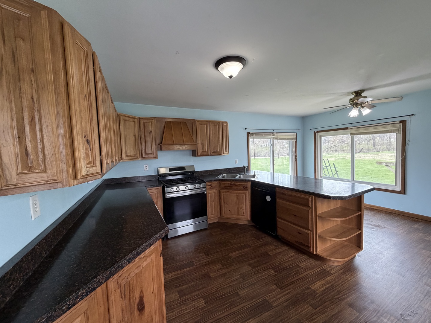 616 East Main Street Amboy, IL 61310 - Photo 24 of 24 a kitchen with stainless steel appliances granite countertop a stove a sink and a window