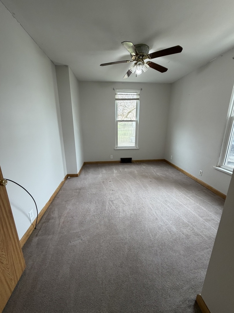 616 East Main Street Amboy, IL 61310 - Photo 7 of 24 a view of a livingroom with a ceiling fan and window