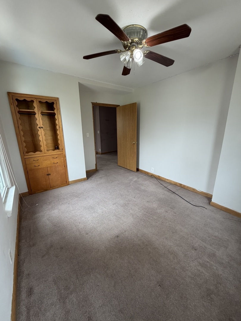 616 East Main Street Amboy, IL 61310 - Photo 8 of 24 a view of a livingroom with a ceiling fan and window