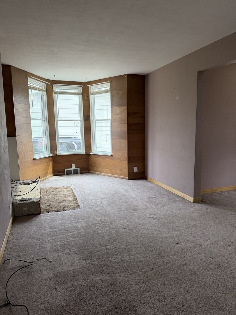 616 East Main Street Amboy, IL 61310 - Photo 9 of 24 an empty room with a couch