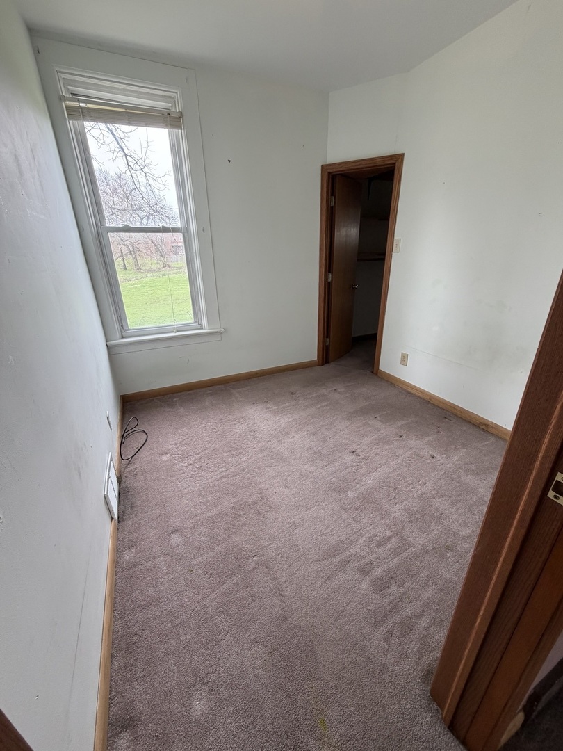 616 East Main Street Amboy, IL 61310 - Photo 10 of 24 an empty room with windows