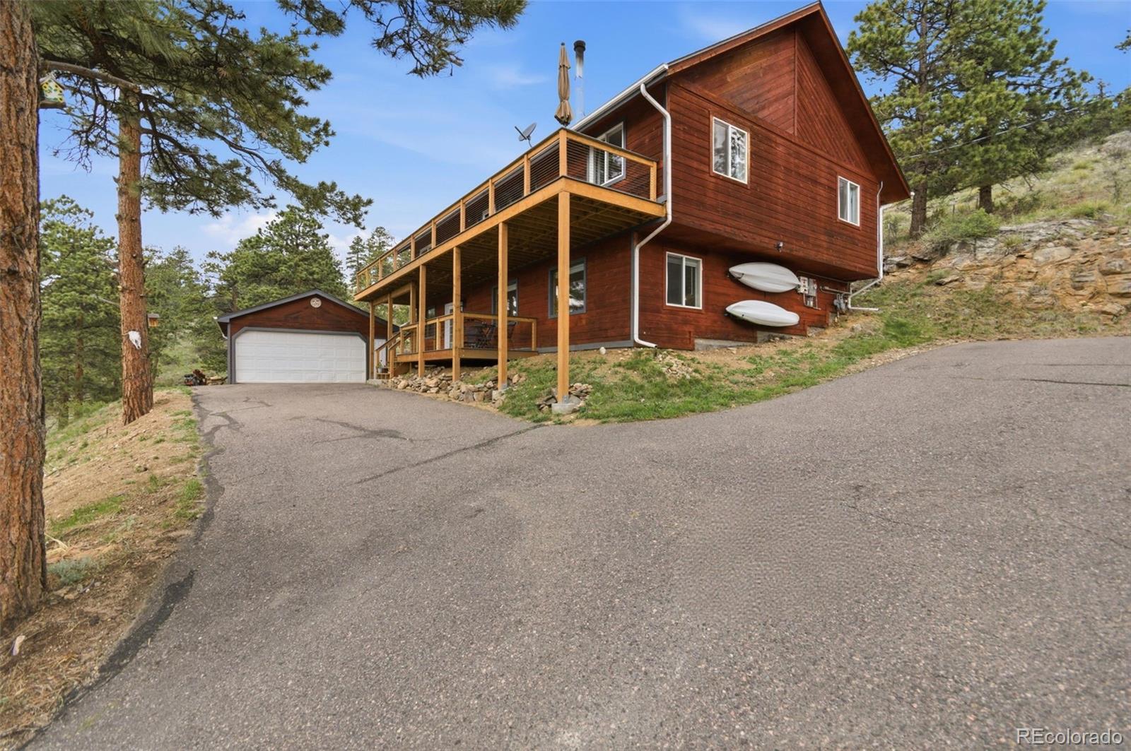 202 Badger Lane Bailey, CO 80421 - Photo 2 of 50 a view of a house with a yard and large tree