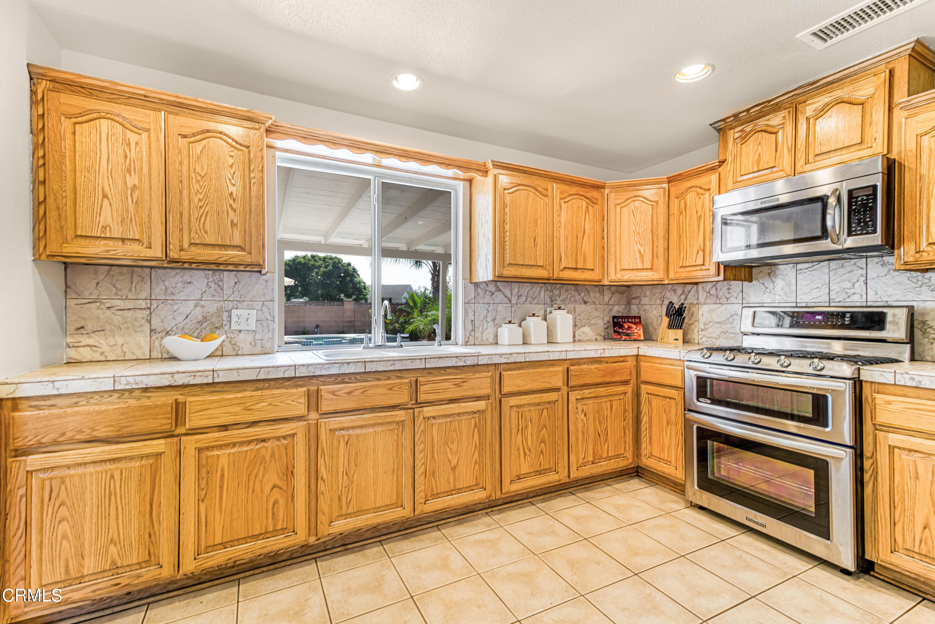 2810 Fitzgerald Road Simi Valley, CA 93065 - Photo 11 of 38 a kitchen with stainless steel appliances granite countertop a stove sink and cabinets