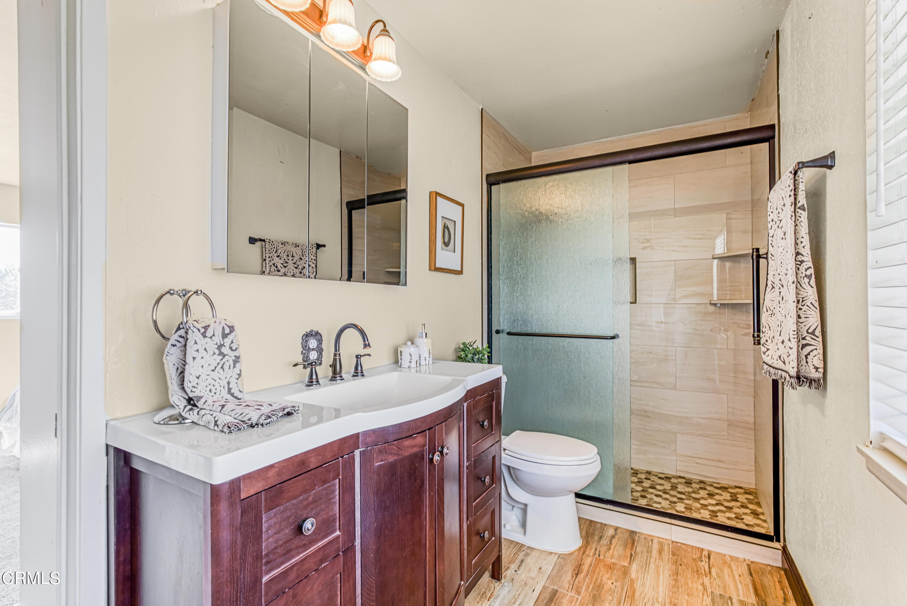 2810 Fitzgerald Road Simi Valley, CA 93065 - Photo 19 of 38 a bathroom with a granite countertop sink a toilet a mirror and shower