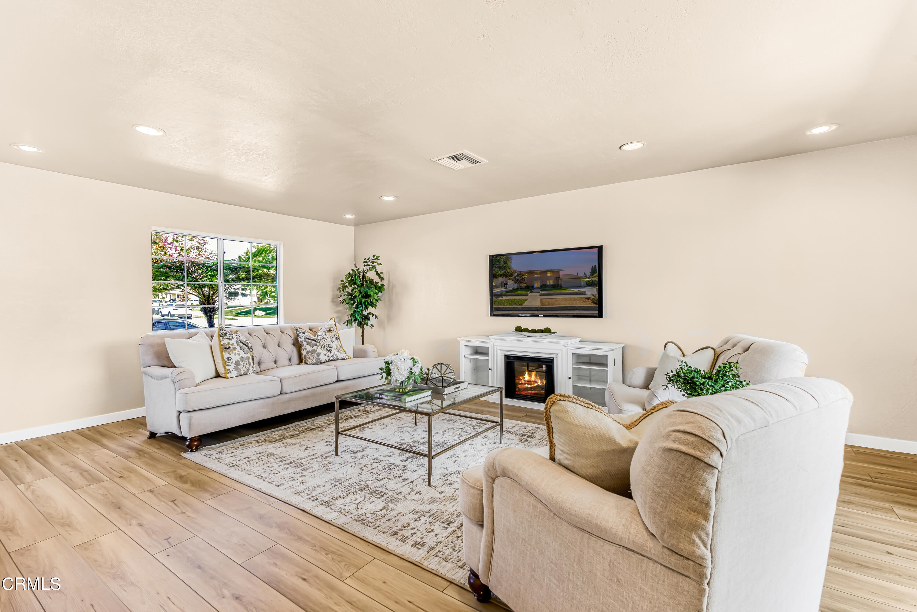 2810 Fitzgerald Road Simi Valley, CA 93065 - Photo 5 of 38 a living room with furniture a flat screen tv and a fireplace