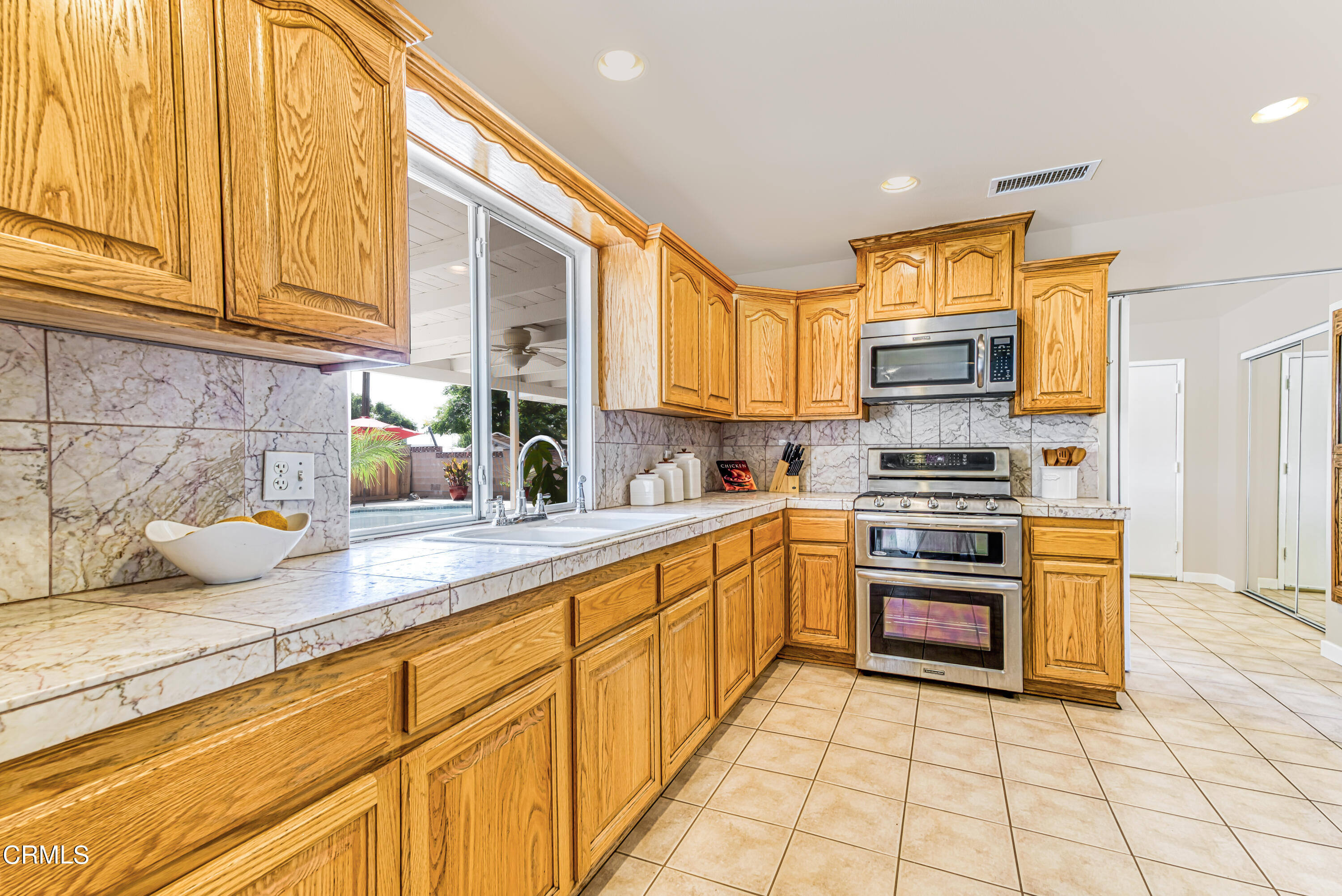2810 Fitzgerald Road Simi Valley, CA 93065 - Photo 10 of 38 a kitchen with stainless steel appliances granite countertop a stove a sink and a refrigerator