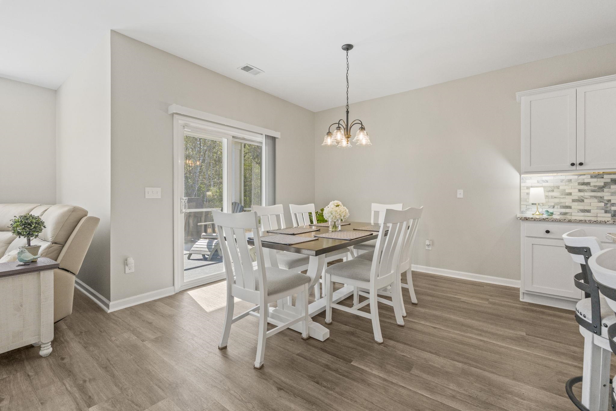 143 Ardeer Court Little River, SC 29566 - Photo 11 of 40 Dining area featuring light wood-type flooring and a chandelier