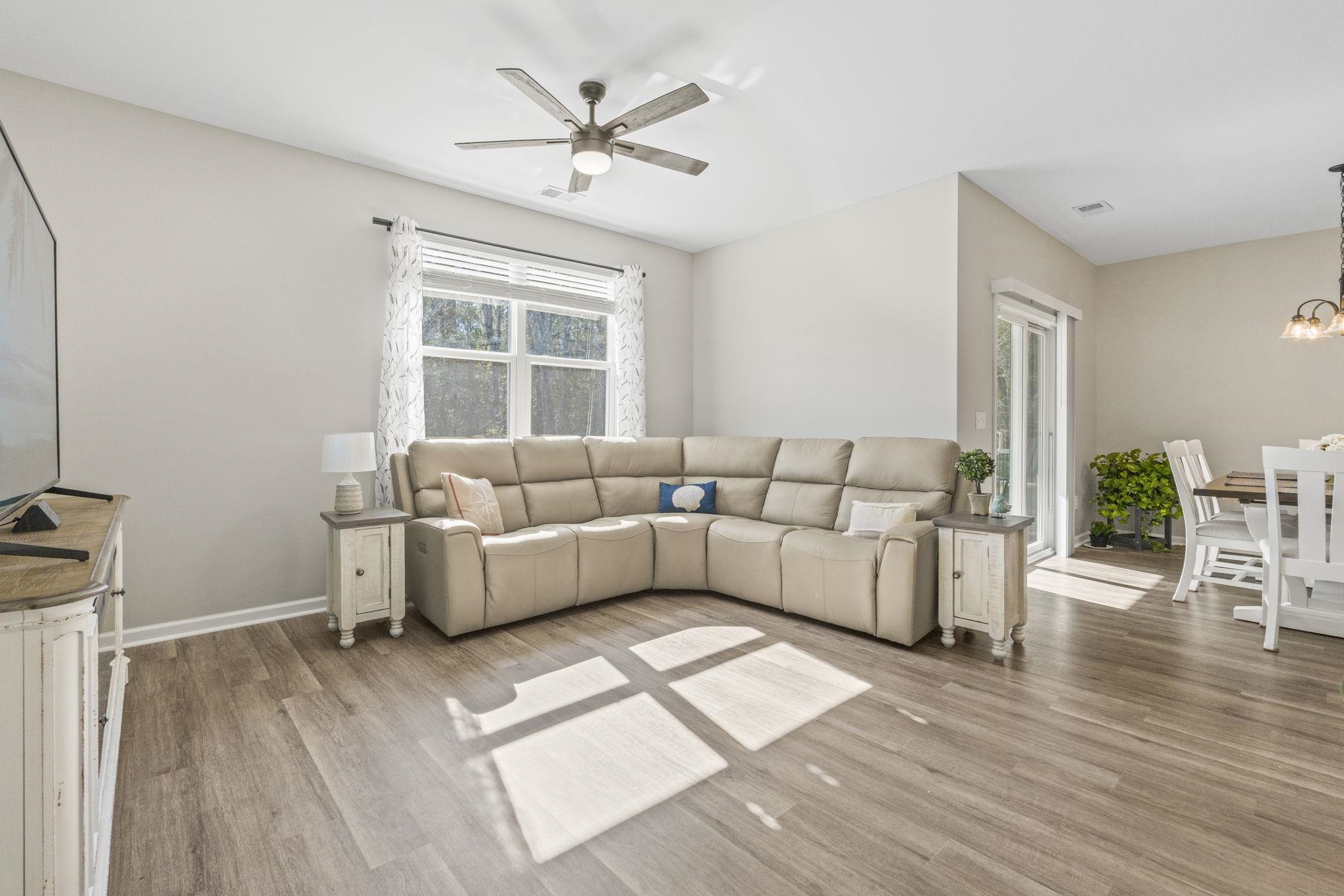 143 Ardeer Court Little River, SC 29566 - Photo 13 of 40 Living room featuring light wood-type flooring, ceiling fan, and a chandelier