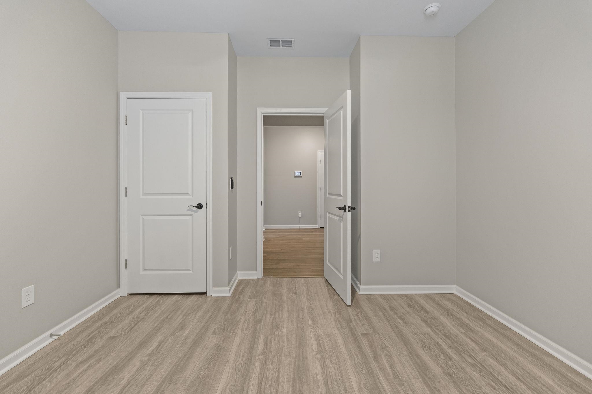 143 Ardeer Court Little River, SC 29566 - Photo 24 of 40 Unfurnished bedroom with light wood-style flooring and baseboards