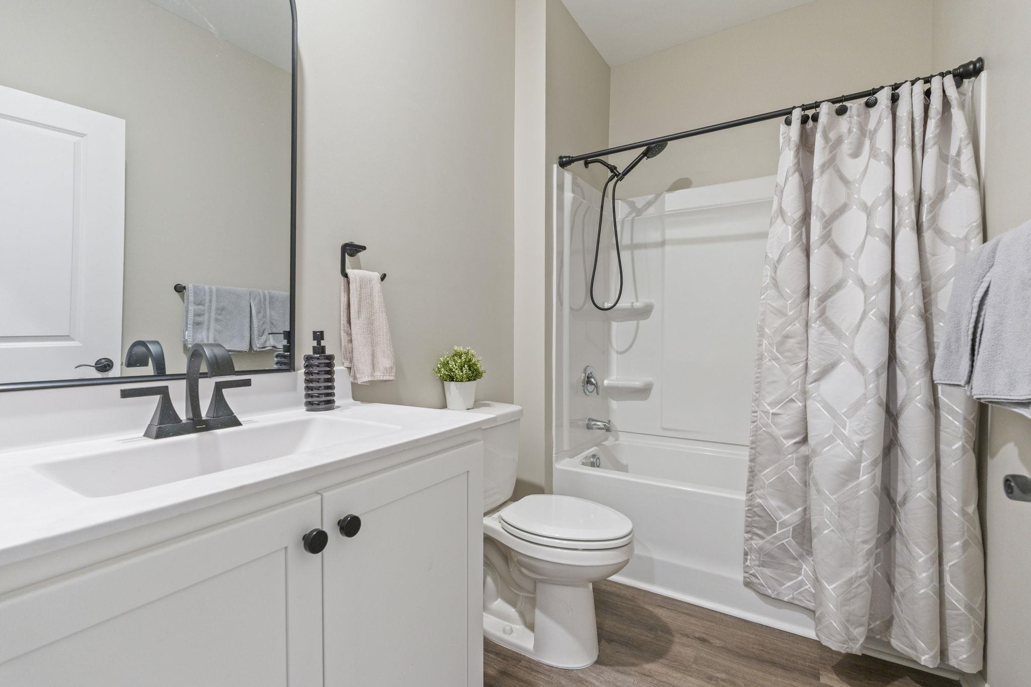 143 Ardeer Court Little River, SC 29566 - Photo 26 of 40 Full bathroom with shower / bathtub combination with curtain, vanity, and dark wood-style flooring