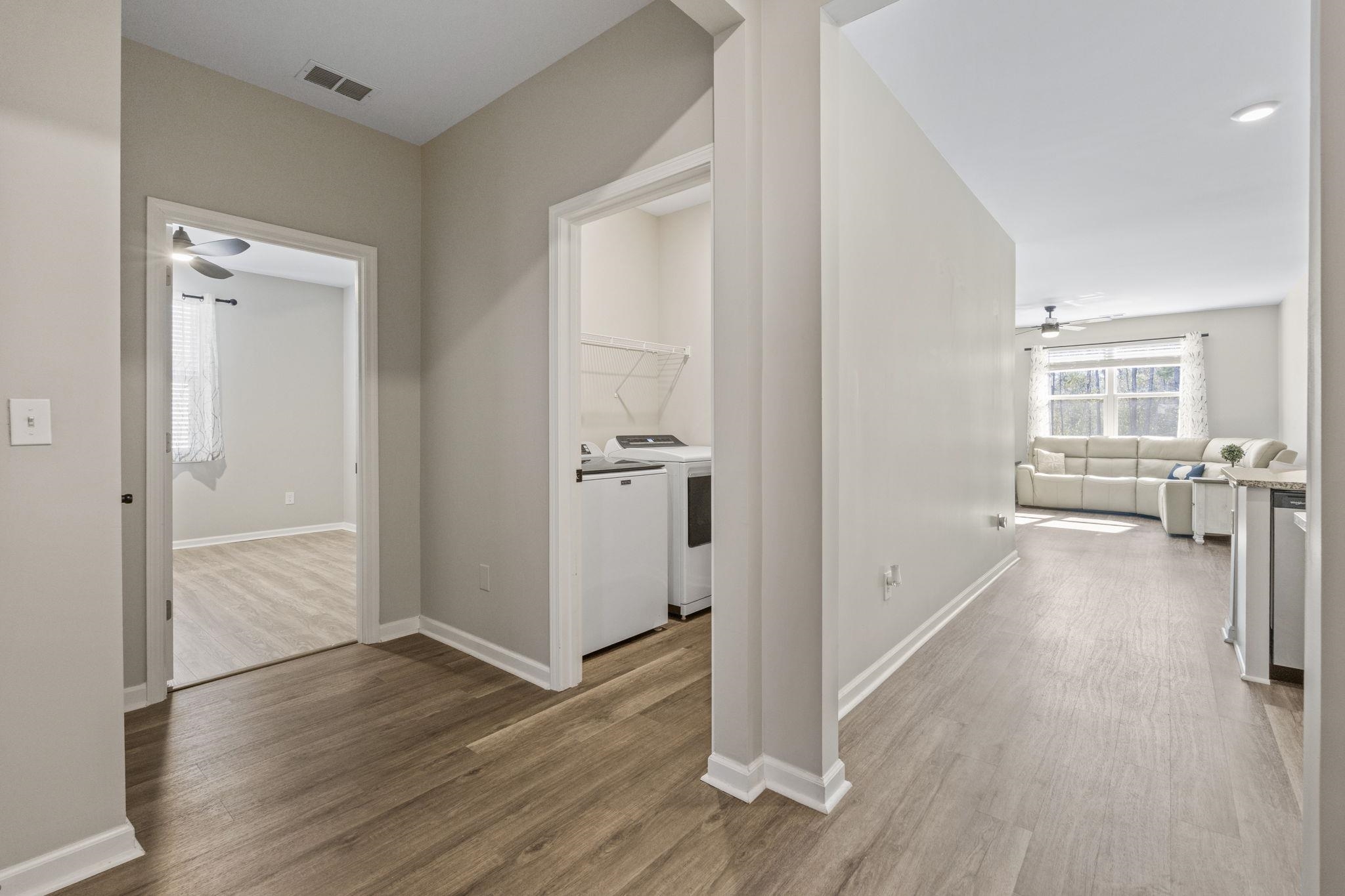 143 Ardeer Court Little River, SC 29566 - Photo 29 of 40 Hallway with separate washer and dryer and wood finished floors