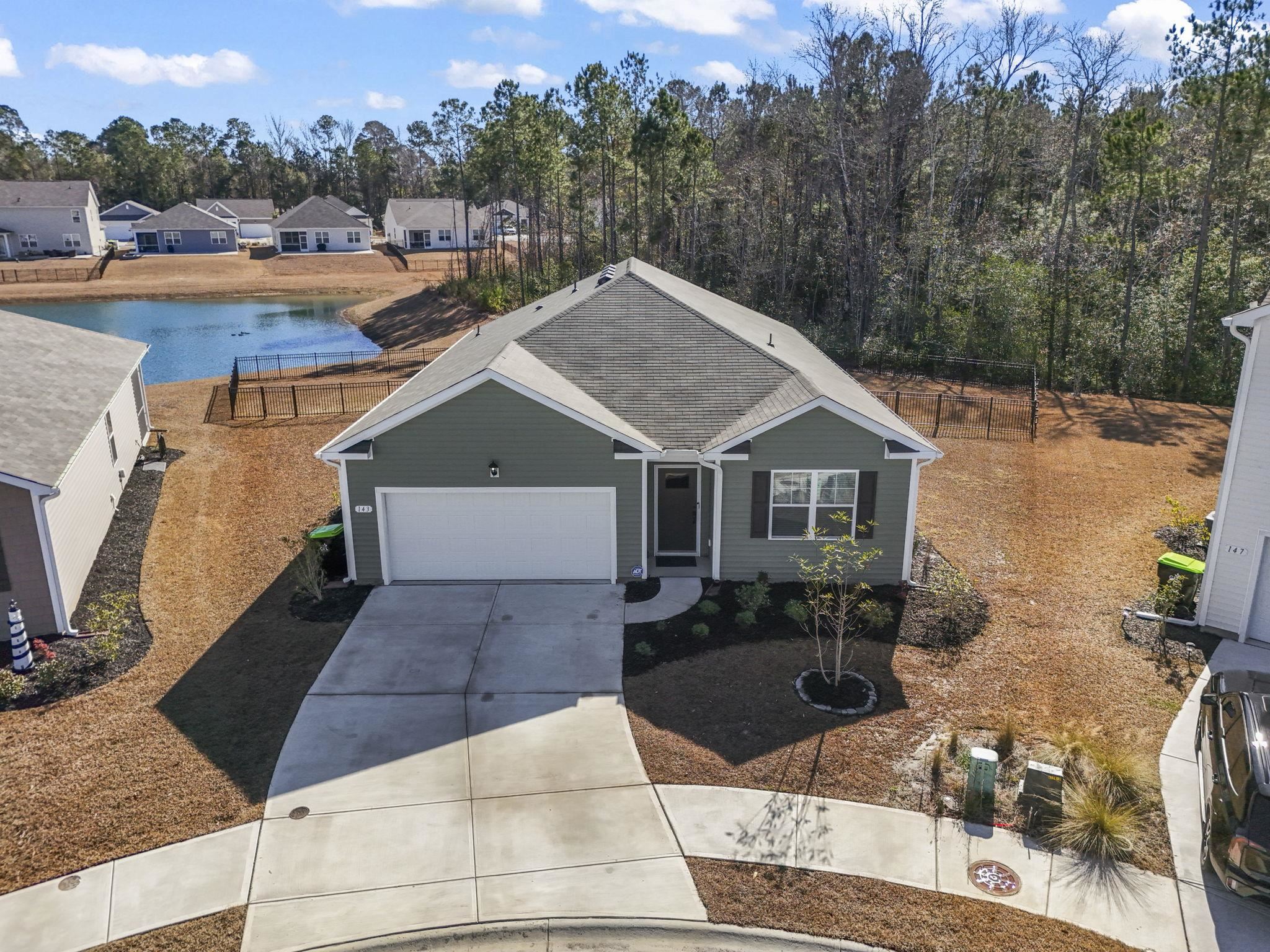 143 Ardeer Court Little River, SC 29566 - Photo 38 of 40 Ranch-style house with a water view, concrete driveway, a garage, and a shingled roof