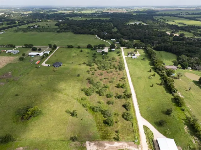 an aerial view of a residential houses with outdoor space