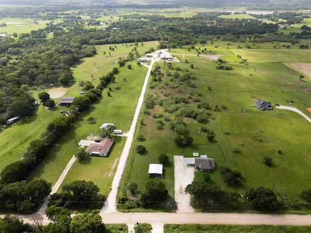 an aerial view of residential houses with outdoor space