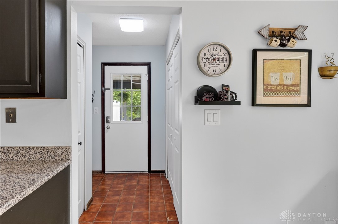 2165 Stewart Road Xenia, OH 45385 - Photo 12 of 59 This bright entry features durable tiled flooring and a convenient kitchen counter with granite.