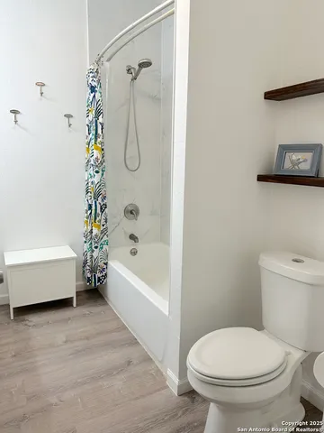 a bathroom with a toilet and a bathtub