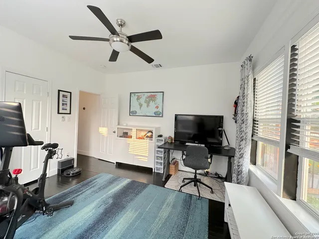 a living room with furniture and a flat screen tv with wooden floor