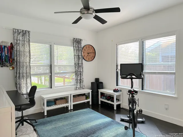 a view of a livingroom with workspace and a window