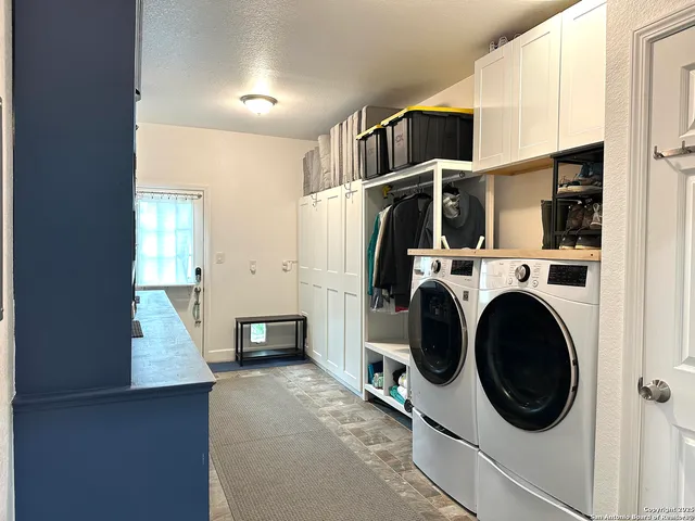 a utility room with closet dryer and washer