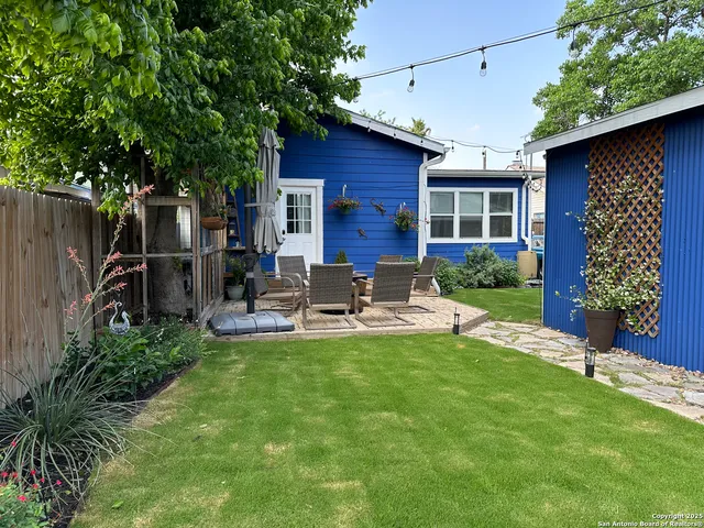 a view of a house with backyard porch and sitting area