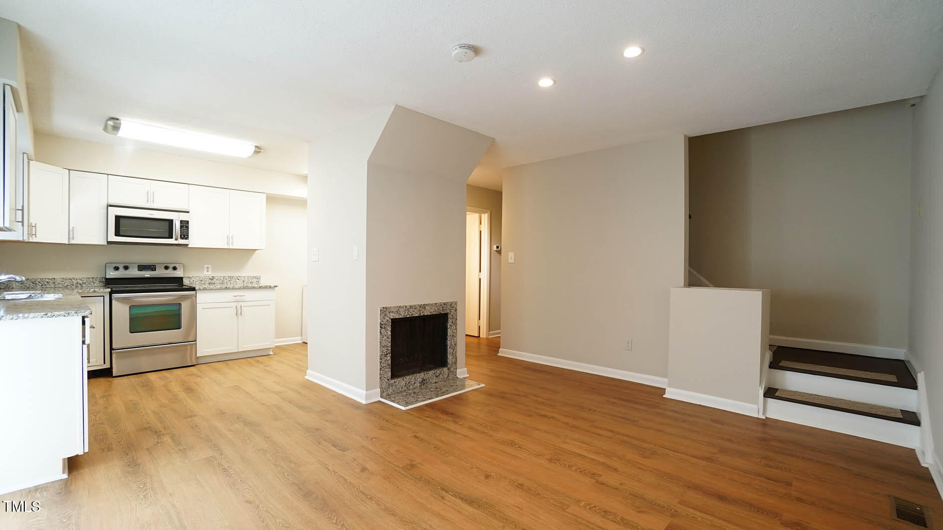 1020 North Bend Drive Raleigh, NC 27609 - Photo 14 of 50 a kitchen with granite countertop a refrigerator and a stove top oven