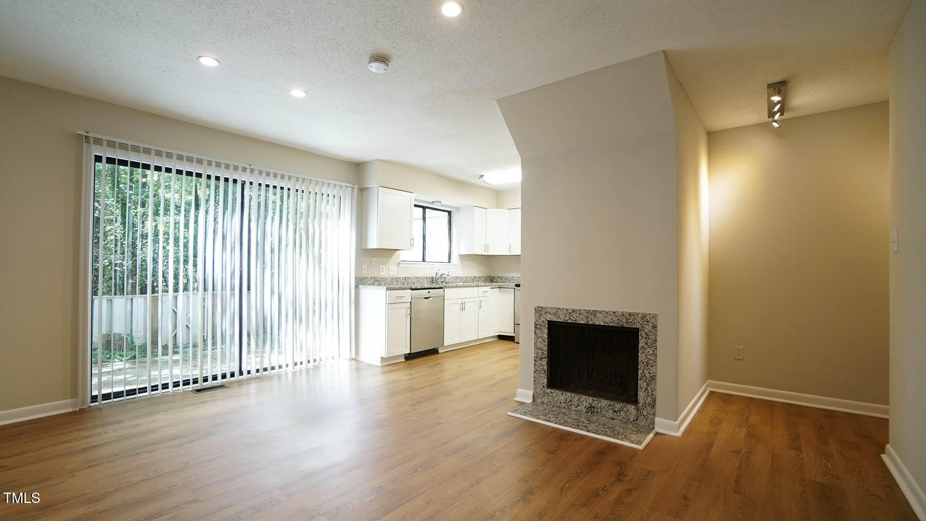 1020 North Bend Drive Raleigh, NC 27609 - Photo 15 of 50 a view of a hallway with an empty room and wooden floor