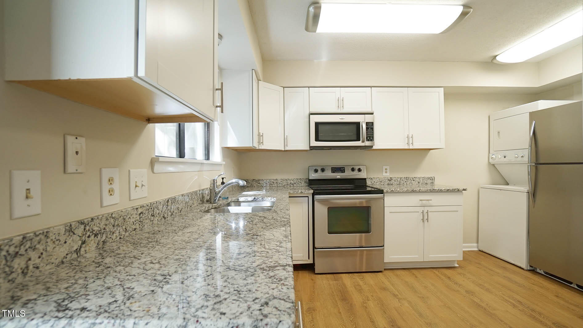1020 North Bend Drive Raleigh, NC 27609 - Photo 17 of 50 a kitchen with stainless steel appliances granite countertop a stove a sink and a microwave