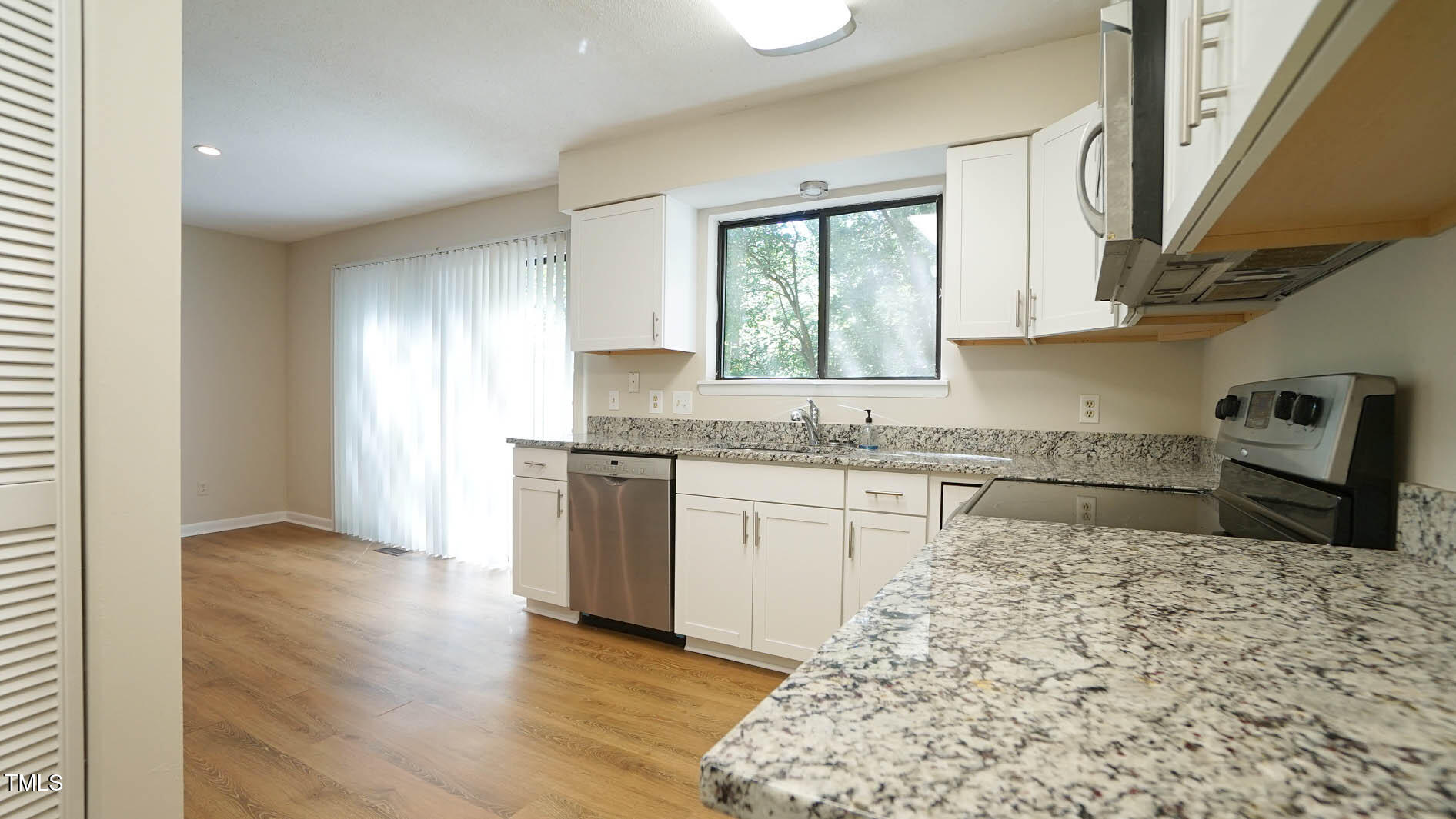 1020 North Bend Drive Raleigh, NC 27609 - Photo 18 of 50 a kitchen with granite countertop a sink and a stove top oven