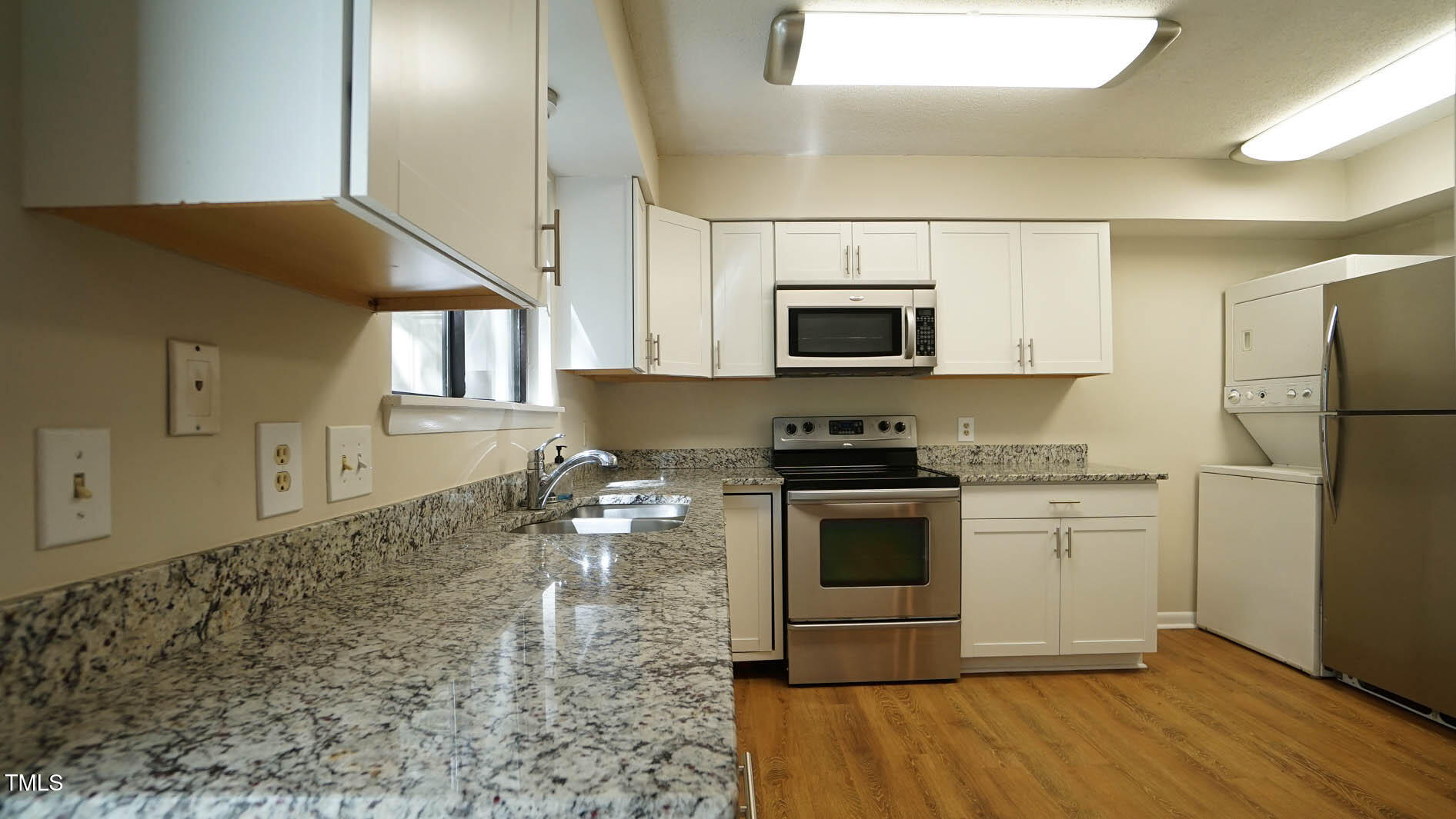1020 North Bend Drive Raleigh, NC 27609 - Photo 20 of 50 a kitchen with stainless steel appliances granite countertop a stove a sink and a microwave