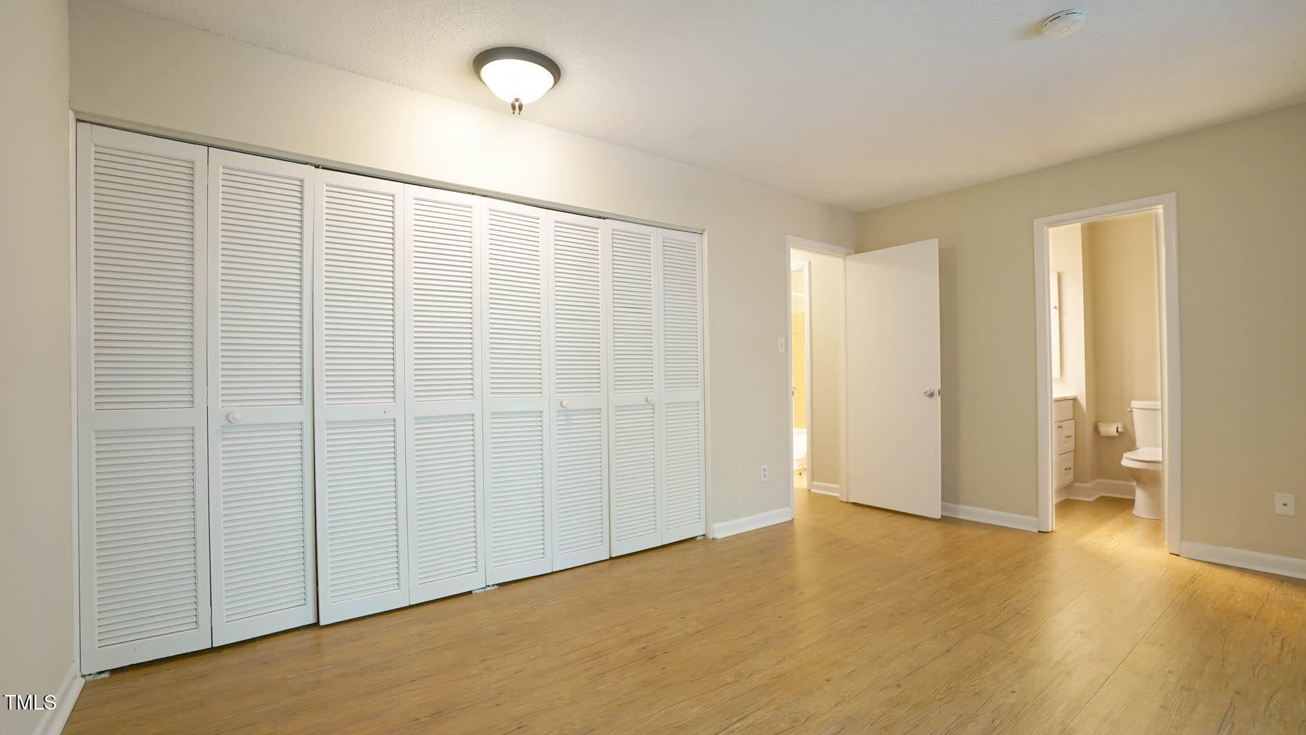 1020 North Bend Drive Raleigh, NC 27609 - Photo 27 of 50 a view of an empty room with wooden floor