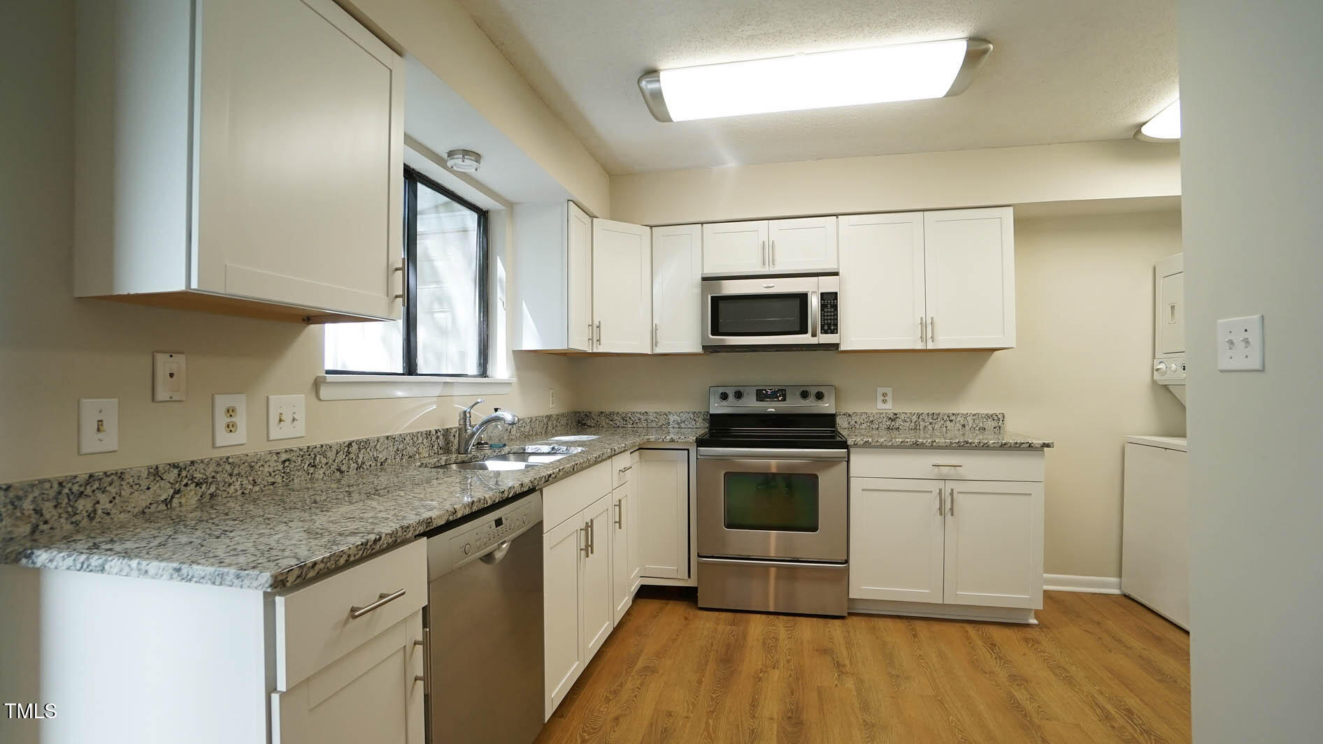 1020 North Bend Drive Raleigh, NC 27609 - Photo 6 of 50 a kitchen with stainless steel appliances granite countertop a sink stove microwave and refrigerator