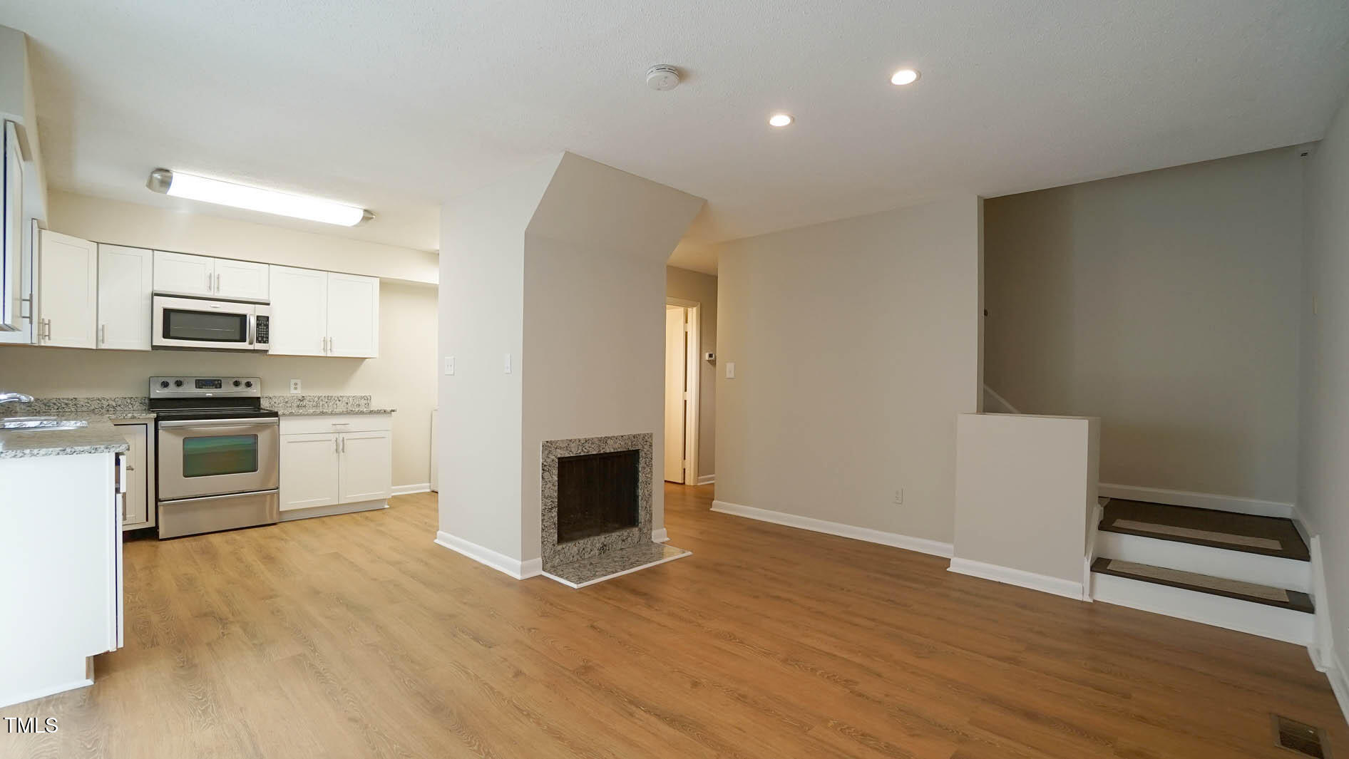 1020 North Bend Drive Raleigh, NC 27609 - Photo 8 of 50 a kitchen with granite countertop a refrigerator and a stove top oven