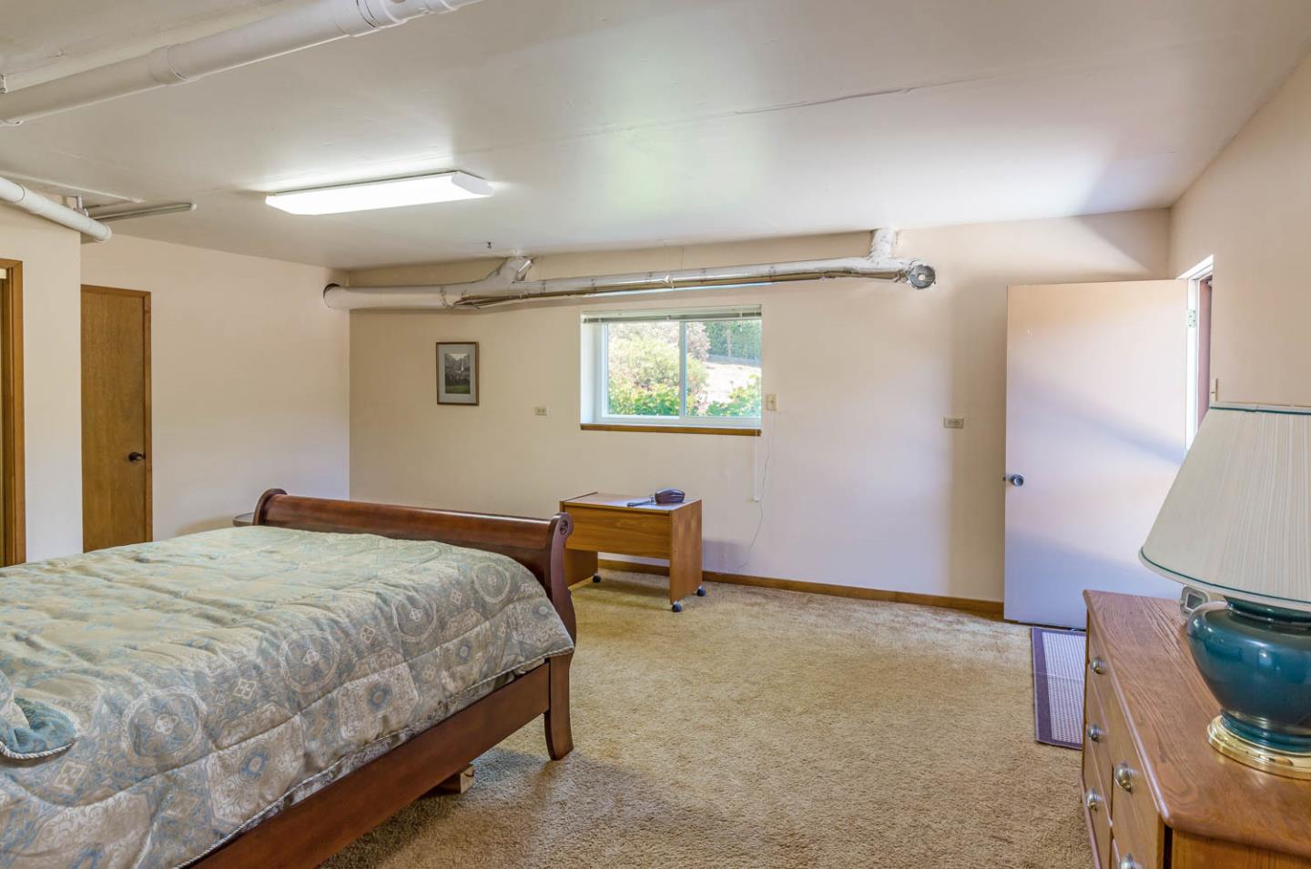 4131 Alpine Road Portola Valley, CA 94028 - Photo 22 of 33 a bedroom with a bed a chair and a dresser in it