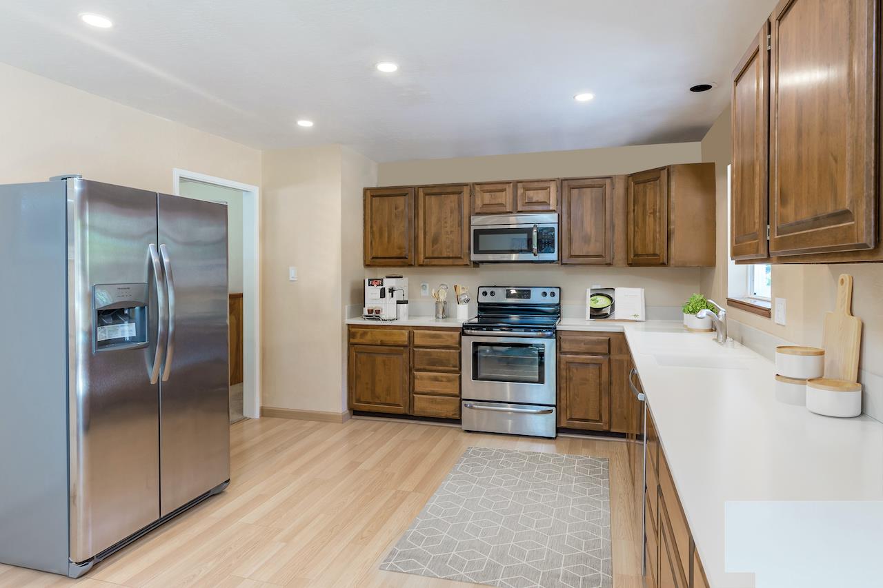 4131 Alpine Road Portola Valley, CA 94028 - Photo 9 of 33 a kitchen with stainless steel appliances cabinets a sink and a refrigerator