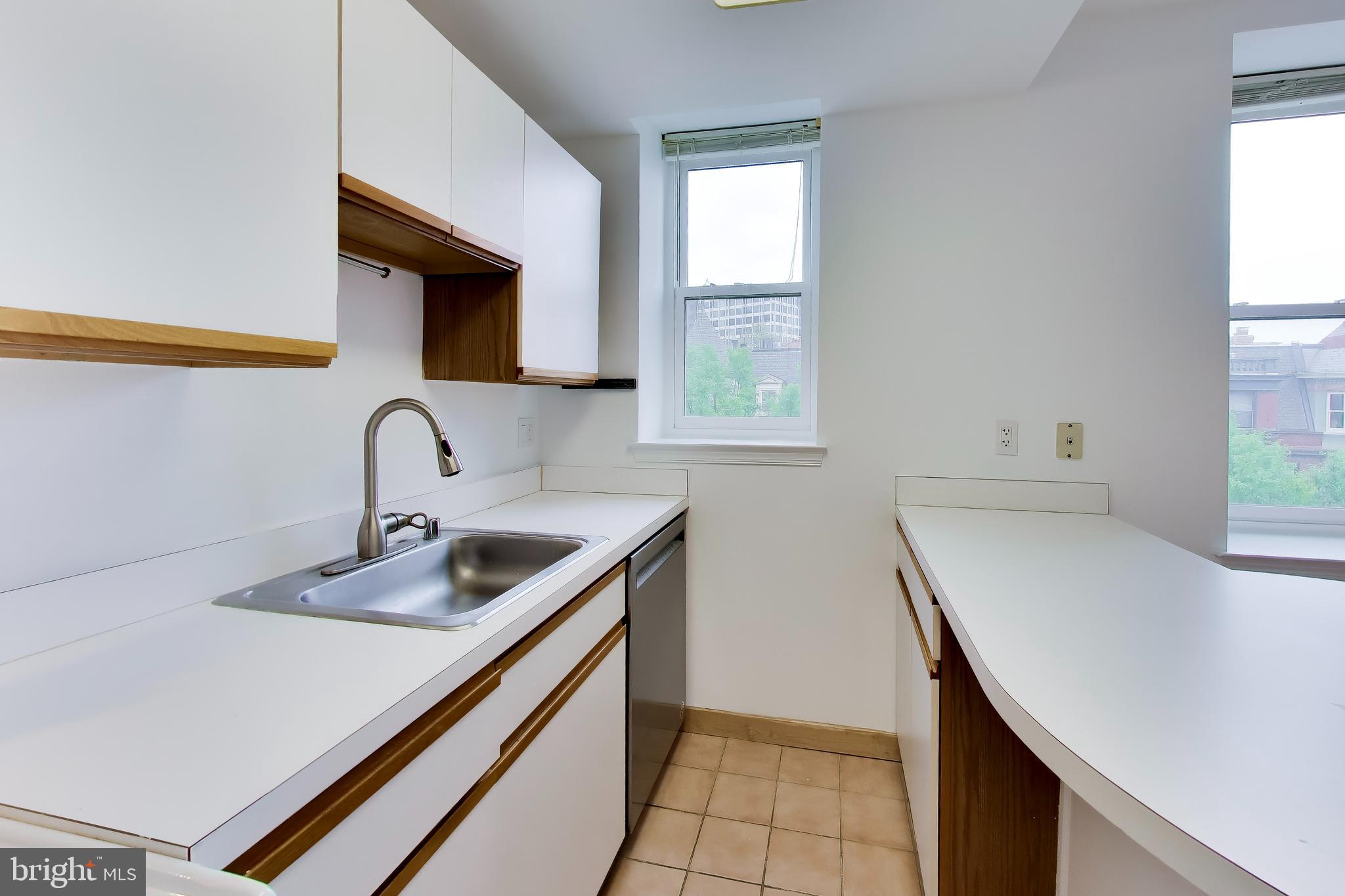 1920 S Street Northwest, Unit 403 Washington, DC 20009 - Photo 7 of 13 a kitchen with a sink cabinets and window