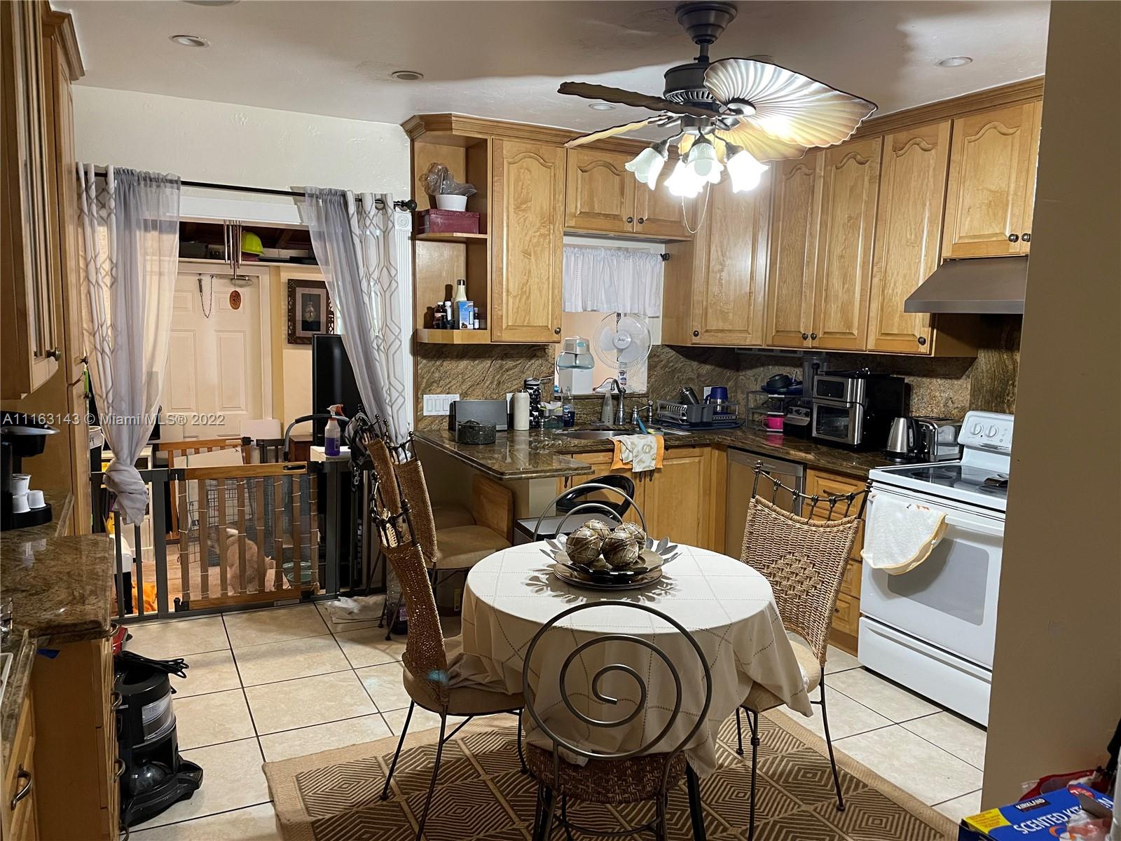 1111 Southwest 11th Avenue Miami, FL 33129 - Photo 11 of 28 a kitchen with a sink stove and cabinets