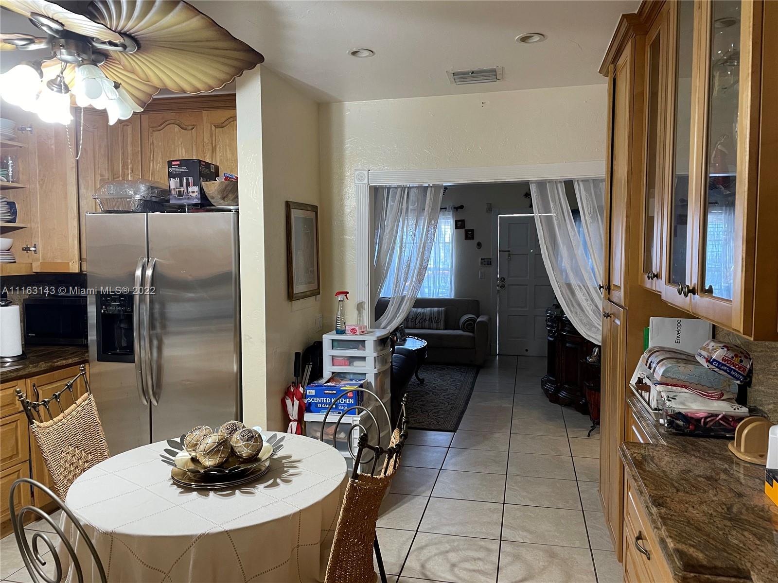 1111 Southwest 11th Avenue Miami, FL 33129 - Photo 16 of 28 a kitchen with sink refrigerator and cabinets