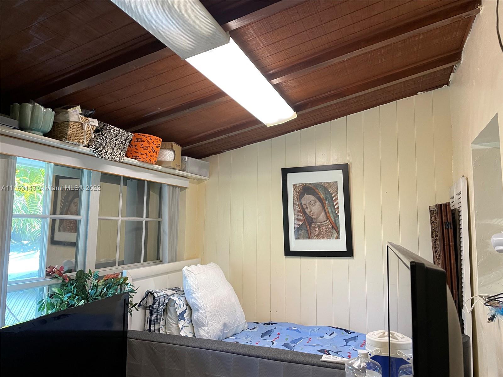 1111 Southwest 11th Avenue Miami, FL 33129 - Photo 17 of 28 a bed room with furniture and a window