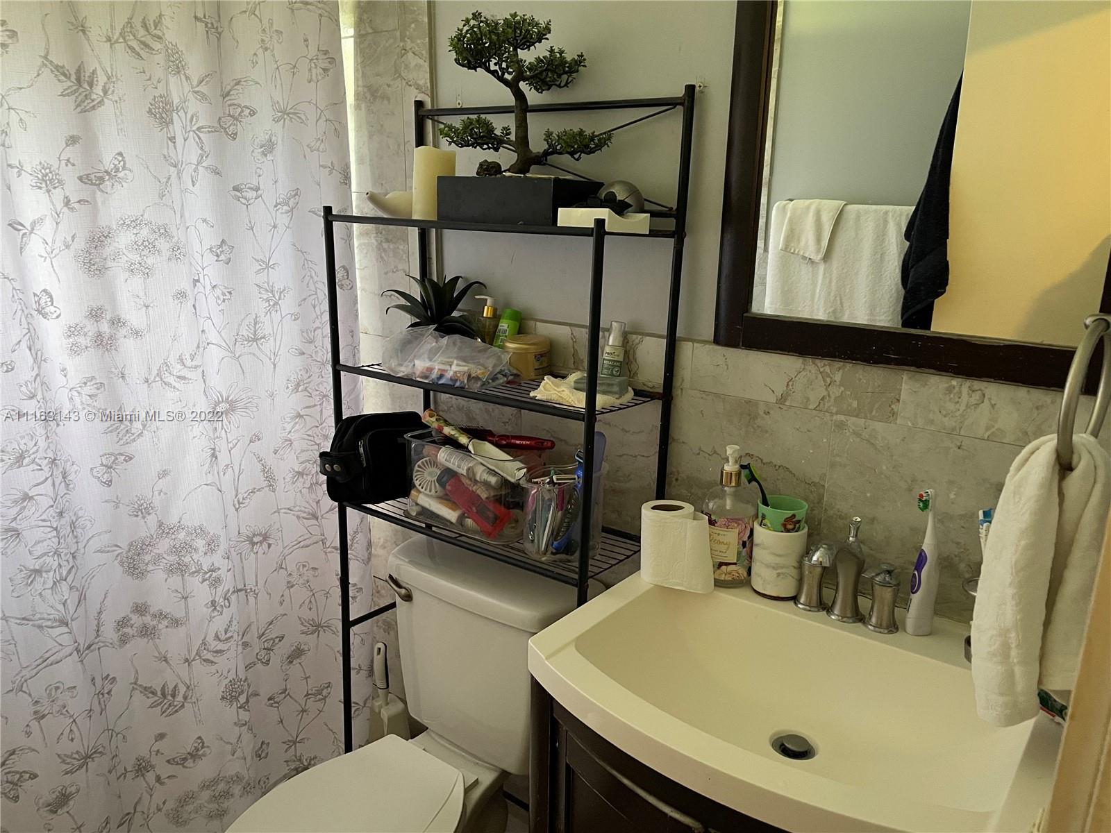1111 Southwest 11th Avenue Miami, FL 33129 - Photo 18 of 28 a bathroom with a sink and a toilet