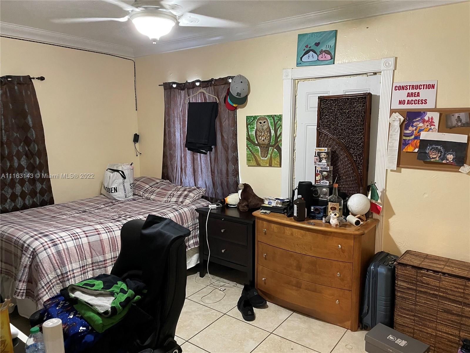 1111 Southwest 11th Avenue Miami, FL 33129 - Photo 19 of 28 a bedroom with a bed dresser and a flat tv screen