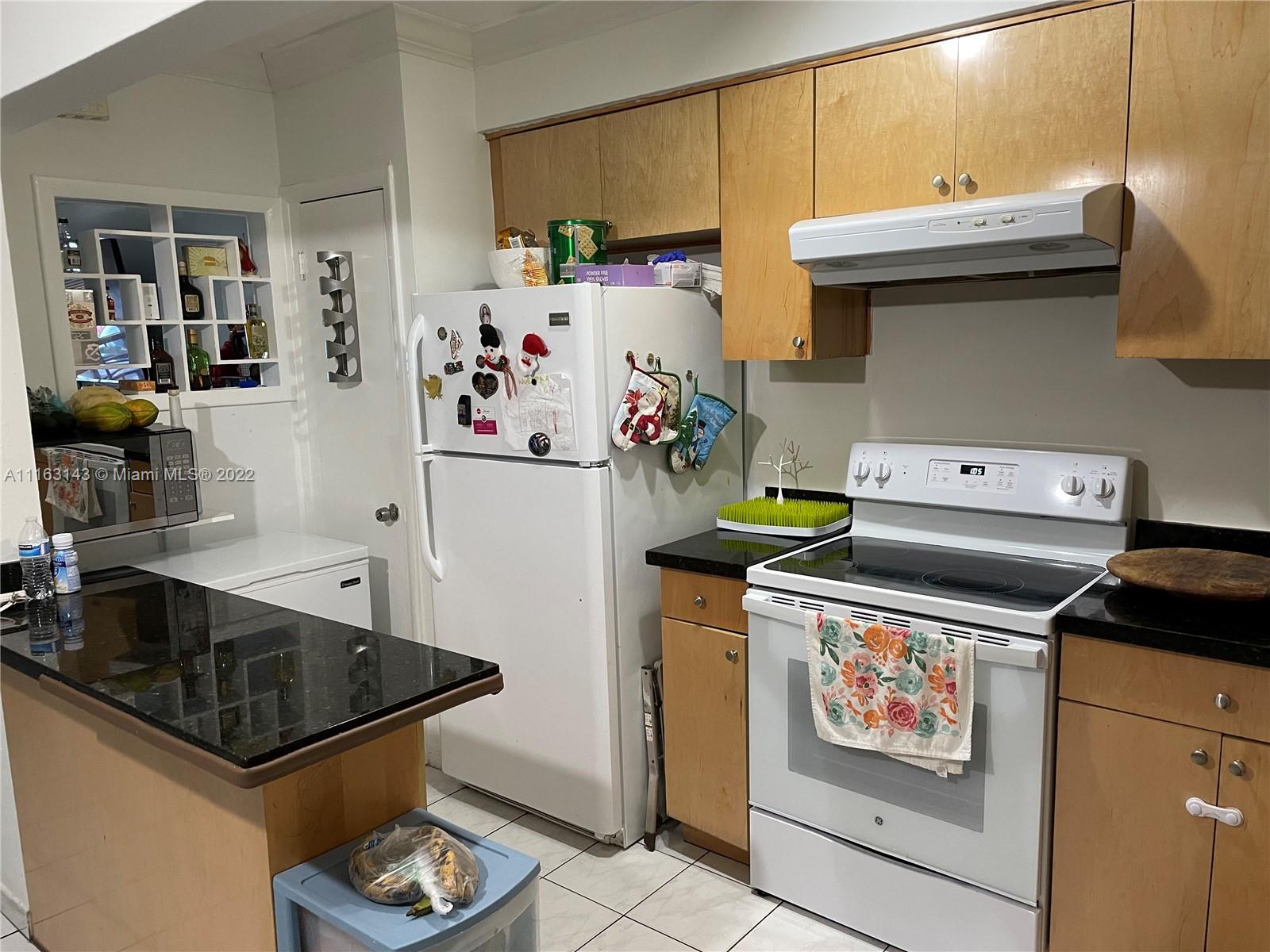 1111 Southwest 11th Avenue Miami, FL 33129 - Photo 23 of 28 a kitchen with stainless steel appliances a stove a refrigerator and a sink
