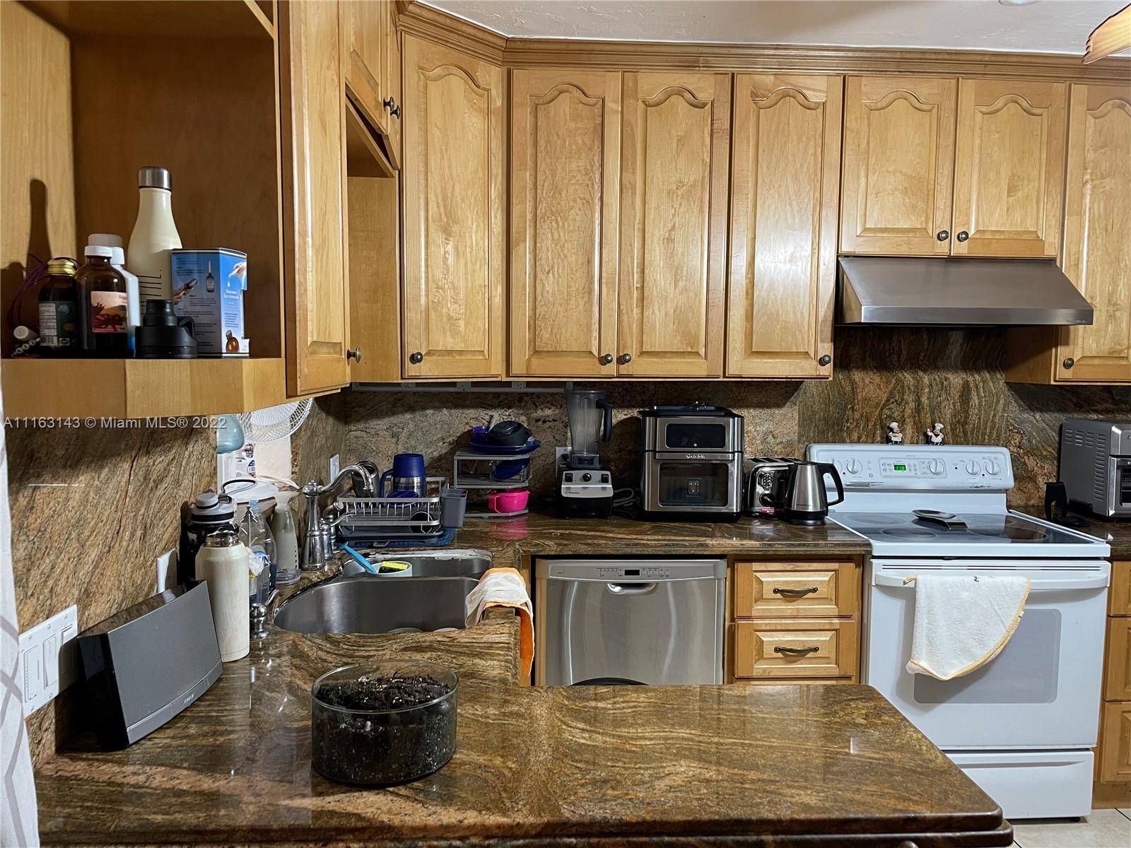 1111 Southwest 11th Avenue Miami, FL 33129 - Photo 5 of 28 a kitchen with a stove a sink and cabinets