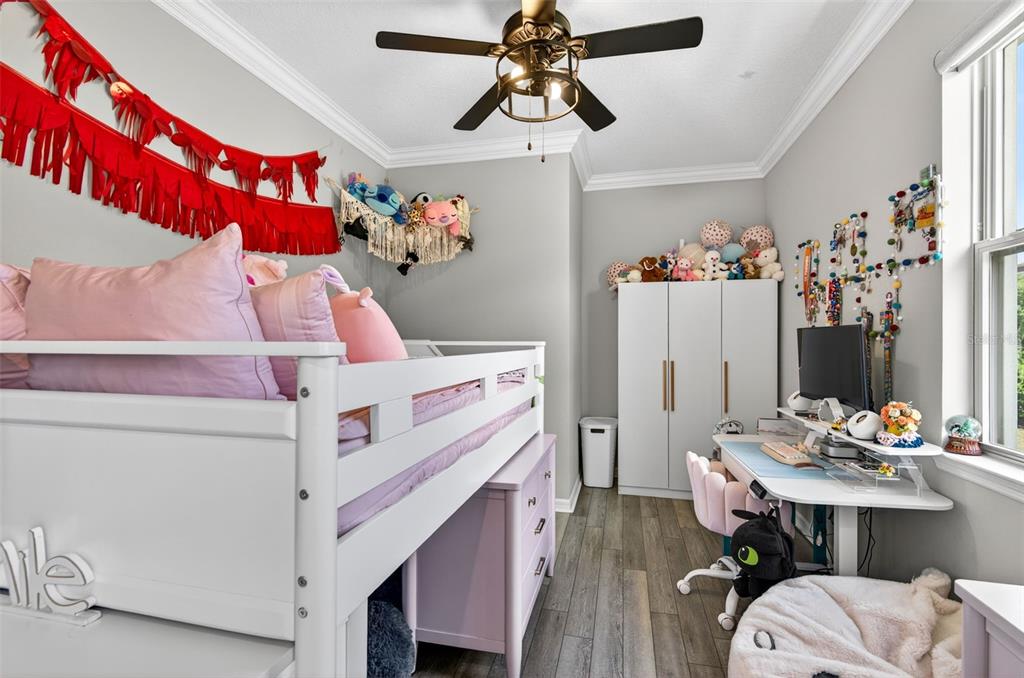 6427 Mooring Line Circle Apollo Beach, FL 33572 - Photo 24 of 34 a bedroom with a bed and a chandelier