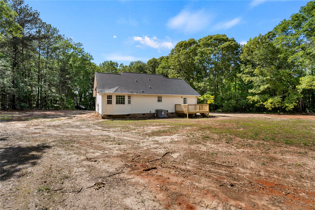 131 Lockaby Road Pelzer, SC 29669 - Photo 38 of 50 This charming home features a deck for outdoor enjoyment, surrounded by mature trees.