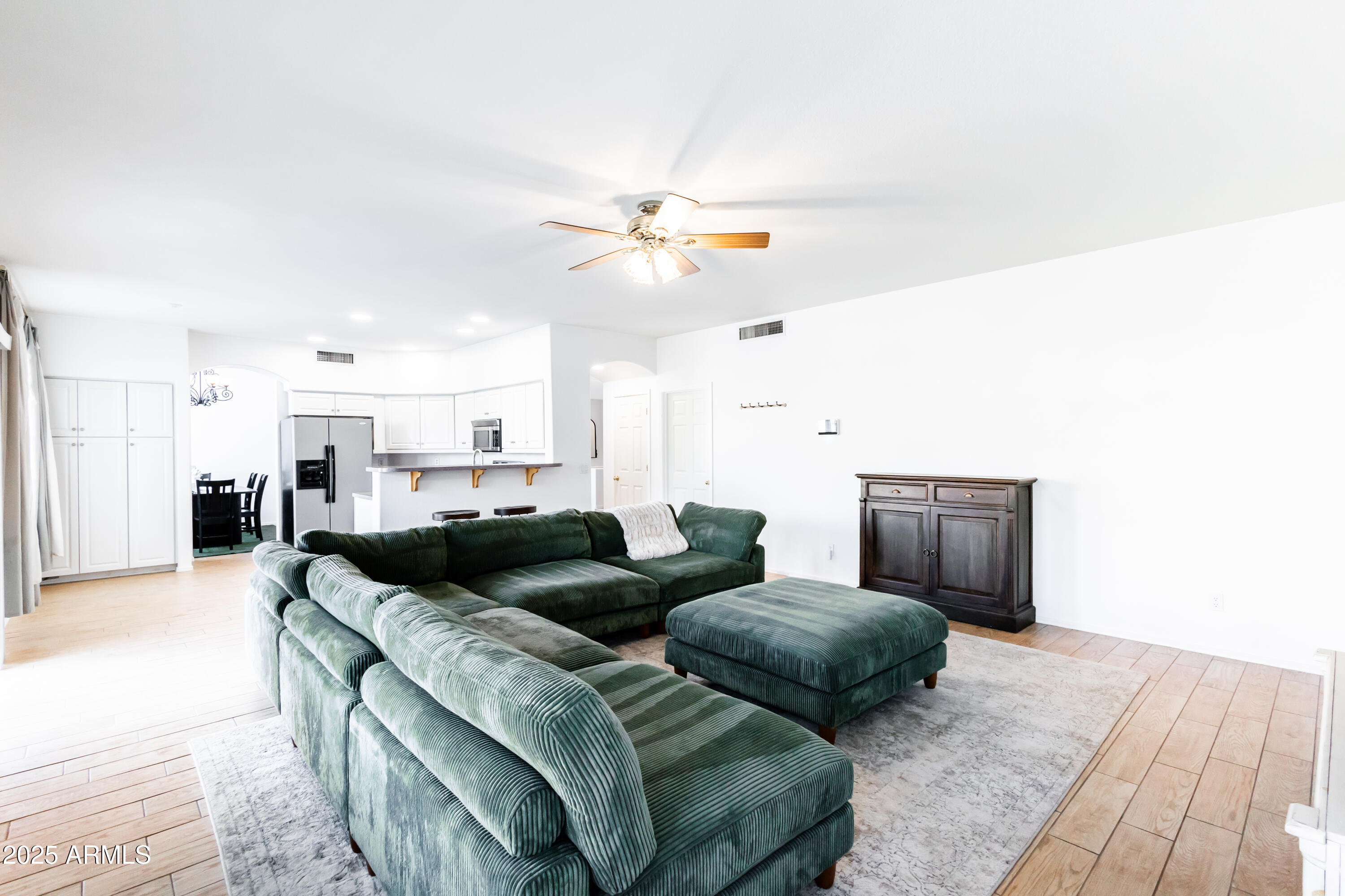 696 West Del Rio Street Gilbert, AZ 85233 - Photo 11 of 39 a living room with furniture and a chandelier