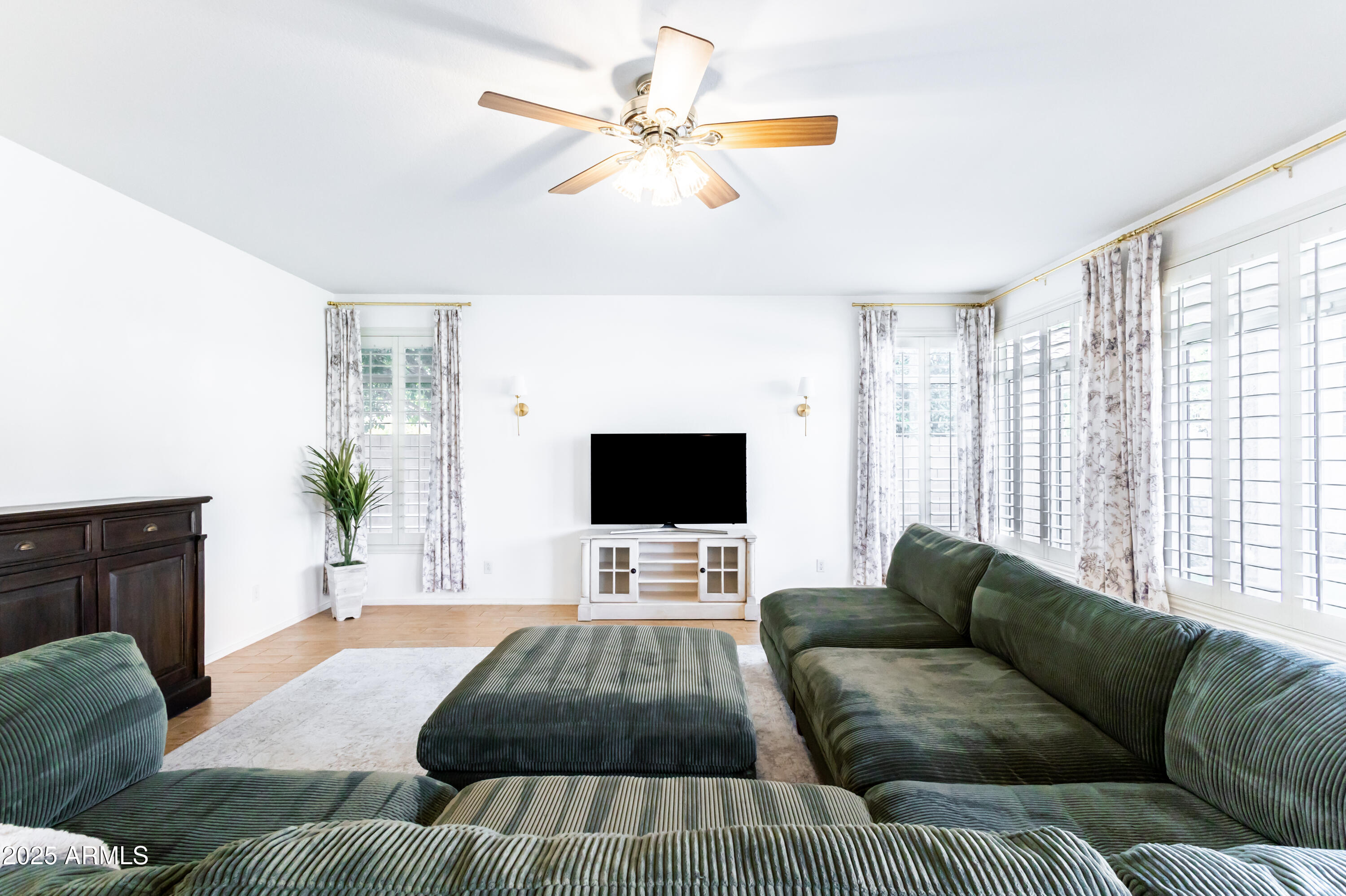 696 West Del Rio Street Gilbert, AZ 85233 - Photo 12 of 39 a living room with furniture and a flat screen tv