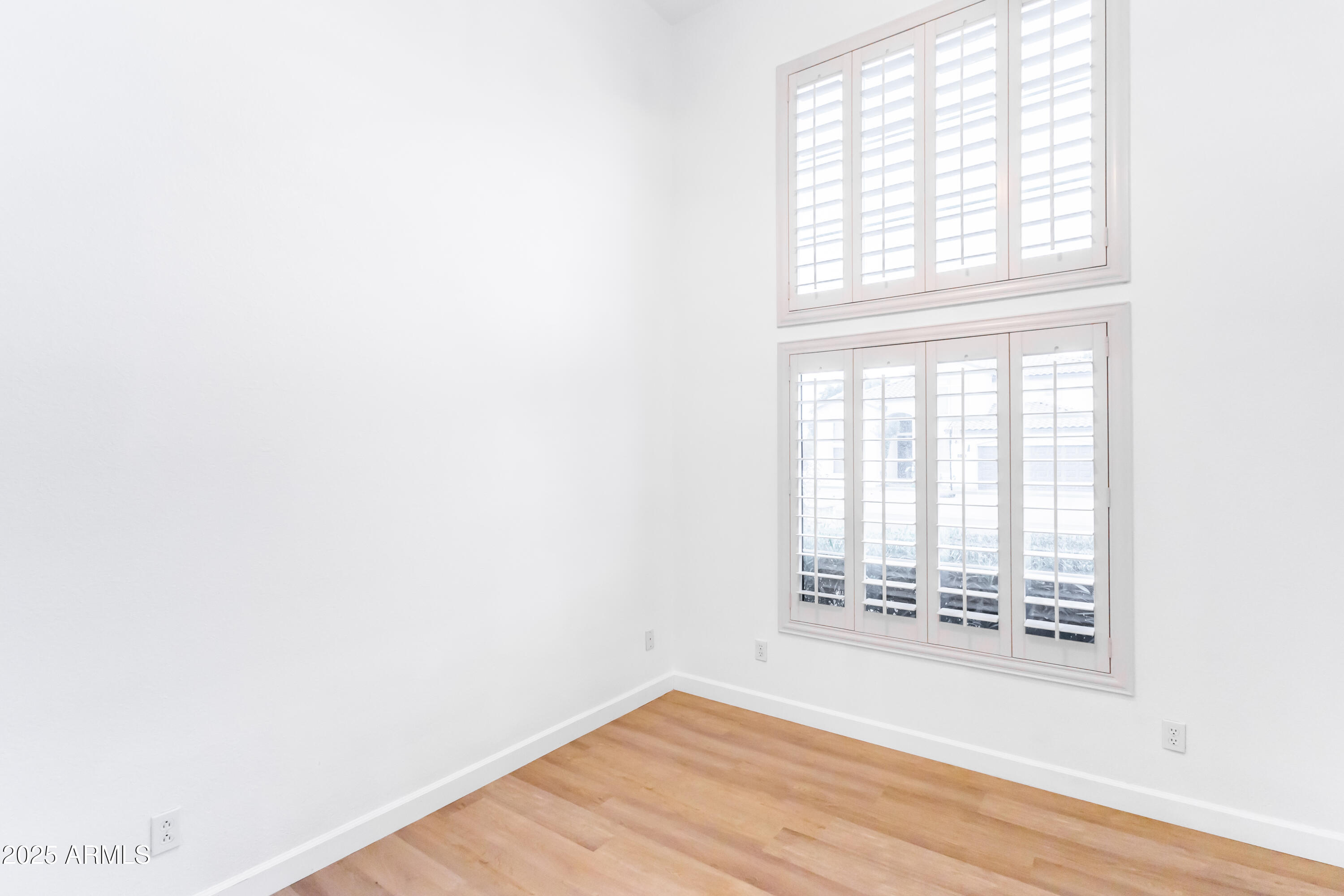 696 West Del Rio Street Gilbert, AZ 85233 - Photo 13 of 39 a view of an empty room with wooden floor and a window